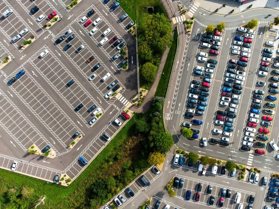 An aerial view of two neighbouring car parks filled with many vehicles