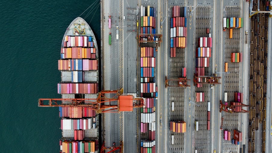 An aerial view of a container ship docked in a harbour