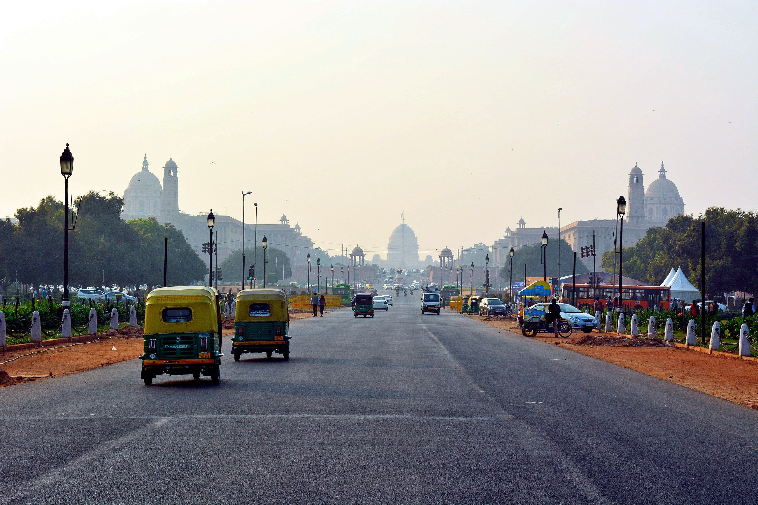 Traffic on a road in India leading to a city in the distance