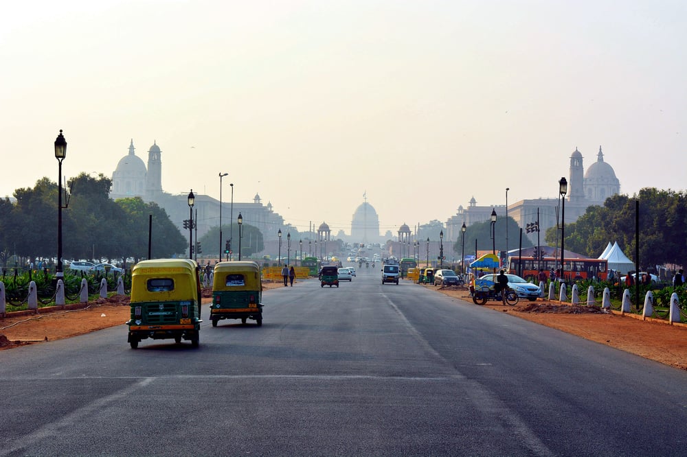 Traffic on a road in India leading to a city in the distance