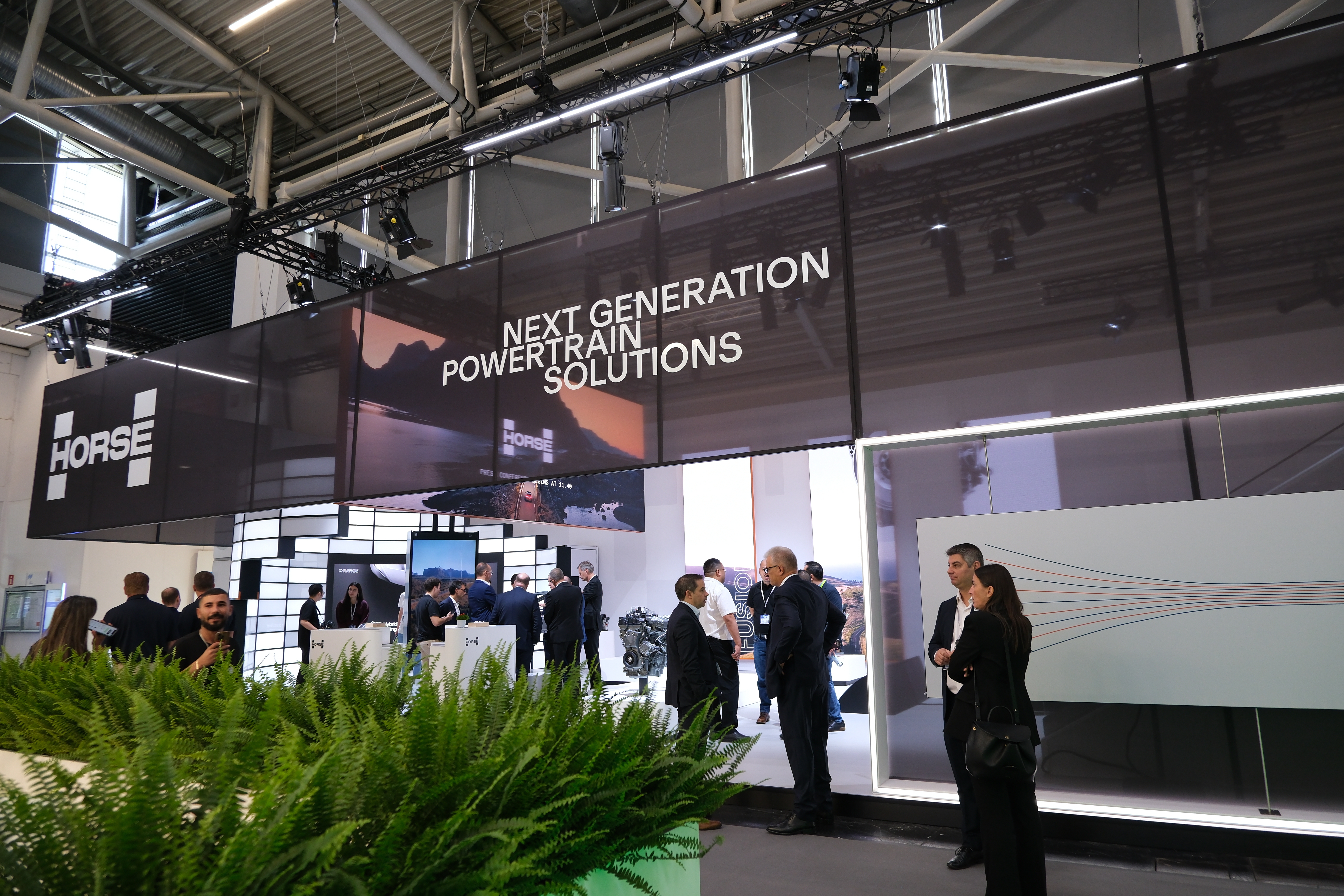 visitors at the IAA trade fair stand at the Horse Powertrain stand